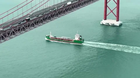 Timelapse of Cargo Ship Passing Under 25 de Abril Bridge Stock-Footage 258774282