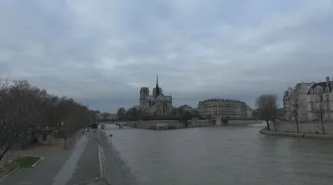 Timelapse Cathedral Notre Dame de Paris and Île de la Cité river sena cloudy day Stock Footage 10760177