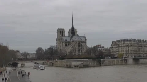 Timelapse Cathedral Notre Dame de Paris and Île de la Cité cloudy day river sena Stock Footage 10760342