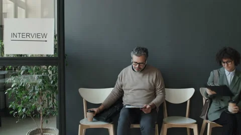 Timelapse Of Caucasian Man Waiting For Interview While People Coming Leaving Stock Footage 236702351