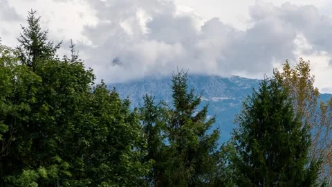 Timelapse, changing shape and texture of clouds in the background of a mountain  Stock Footage 286415177