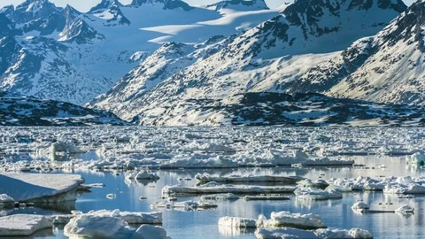 Timelapse of chunks of ice moving and melting on lake water surface on sunny day Stock Footage 124239638