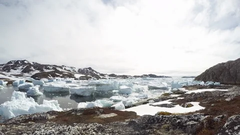 Timelapse of chunky ice melting and floating on lake water surface in mountains Stock Footage 124239746