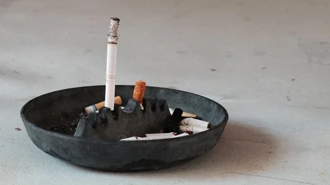 Timelapse of a cigarette kept upright on a black ash tray Stock Footage 115464945