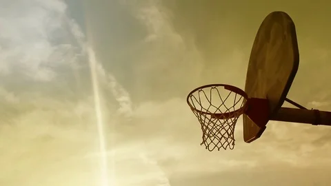 Timelapse of Cinematic Sunset near a basketball hoop in summer Stock Footage