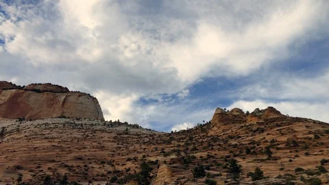 Timelapse of cirrus clouds passing over slickrock mountain in Zion National Park Stock Footage 113945301
