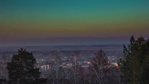 Timelapse city behind the forest sunset leaving at dusk Stock Footage 212820421