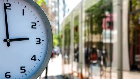 Timelapse of Clock time in front busy city street people passing by backgro.. Stock Footage 272760686