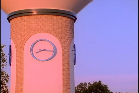 Timelapse clock on water tower day to night Stock Footage 121599318