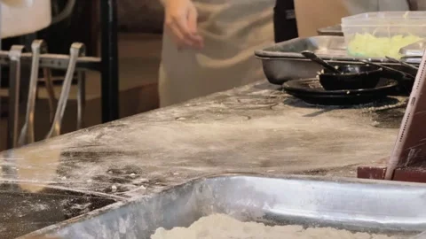 Timelapse close-up of chef hands assembling pizza toppings on rolled dough Stock-Footage 341542494