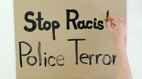Timelapse. close-up, hand writes slogan - Stop Racist Police Terror - with brush Stock Footage 132005245