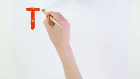 Timelapse. close-up, hand writes slogan - The Time is now - with brush, using Stock Footage 132005383