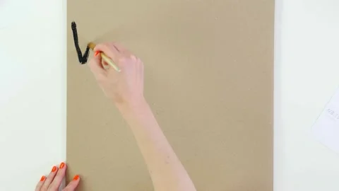 Timelapse. close-up, hand writes slogan - We are ALL HUMAN - with brush, using Stock Footage 132005528