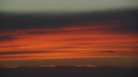 Timelapse - close-up on soft clouds in evening after sunset. Red, orange colors. Stock Footage 67647663