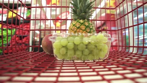 Timelapse close up view the buyer puts fresh fruits and berrys in the red Stock Footage 246589350