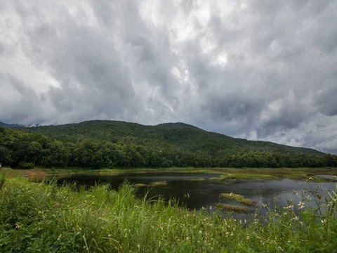 Timelapse cloud and mountain near a large natural or artificial lake Stock Footage