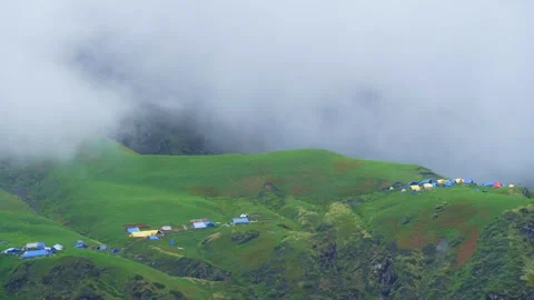 Timelapse of Cloud-Covered Campsite on Lush Green Hills  Colorful Tents in .. Stock Footage 316361070