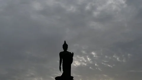 Timelapse of cloud on the dark sky, silhouette buddha image in foreground Stockbeeldmateriaal 92936149