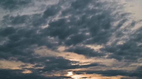 Timelapse of cloud formations in the evening sky, highlighting shifting light Stock Footage 338299537