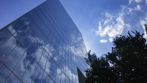 A timelapse of cloud reflecting the office building sunny day Stock Footage 346637141