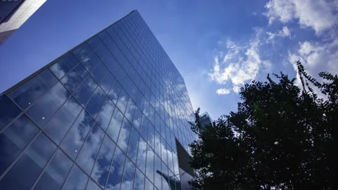A timelapse of cloud reflecting the office building sunny day Stock Footage 346637143