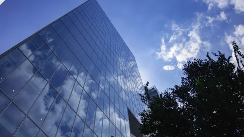 A timelapse of cloud reflecting the office building sunny day Stock Footage 346637148