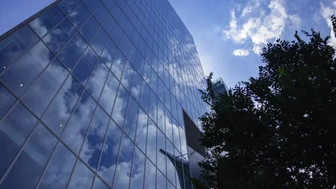 A timelapse of cloud reflecting the office building sunny day Stock Footage 346637149