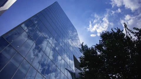 A timelapse of cloud reflecting the office building sunny day Stock Footage 346637206