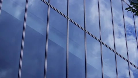 A timelapse of cloud reflecting the office building sunny day Stock Footage 346637221