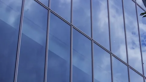 A timelapse of cloud reflecting the office building sunny day Stock Footage 346637236