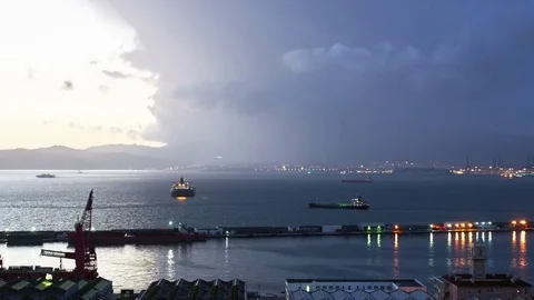 Timelapse of Cloud Rolling in and the Sunsetting over the Port of Gibraltar Stock Footage 77411047