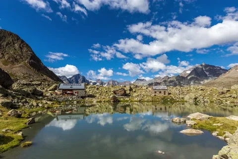 Timelapse of the cloud under the Massif des Ecrins with reflexion on the lake Stock Footage 139798672
