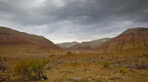 Timelapse of clouds above desert and colored hills Stock Footage 54029379