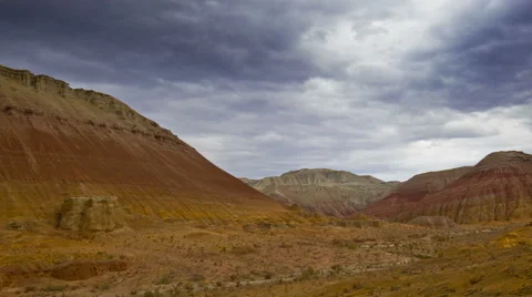 Timelapse of clouds above desert and colored hills Stock Footage 54029567