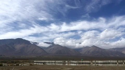 Timelapse of clouds above mountains, on a windy day, in Death valley, Califor Stock Footage 69986361