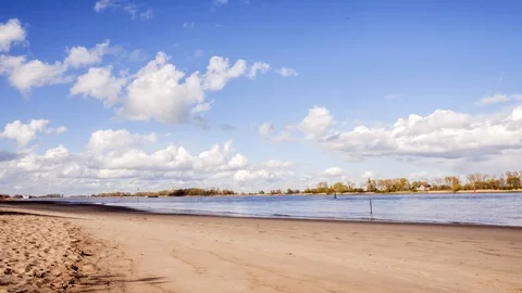 Timelapse of clouds and blue skies over a large river. Stock Footage 127958247