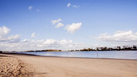 Timelapse of clouds and blue skies over a large river. Stock Footage 127958600