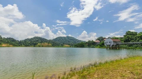 Timelapse clouds and blue sky with Mountain and Lake dam inThailand Stock Footage 55579948