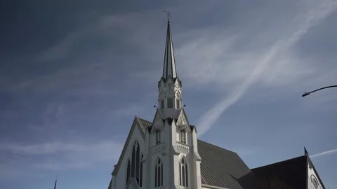 Timelapse of clouds and blue sky above a church steeple. Stock Footage 243668608