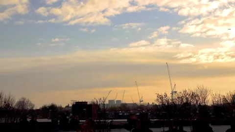 Timelapse of clouds and construction cranes with sunset lighting in London Stock Footage 144285217