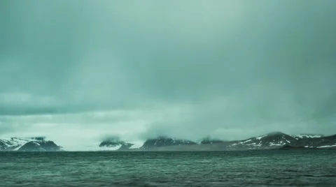 Timelapse clouds and current racing towards arctic mountain range Stock Footage 62126591