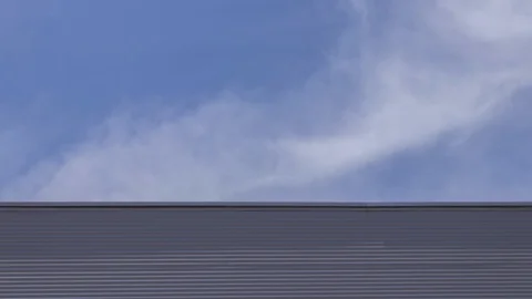Timelapse - Clouds and Metal Warehouse Video stock 112011121