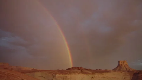 Timelapse of clouds and rainbows at sunset near Lake Powell, UT with Tower Butte Stock Footage 322135117
