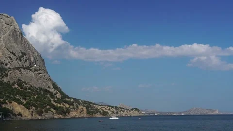 Timelapse of clouds and sea bay surrounded by towering cliffs Stock Footage 165381589