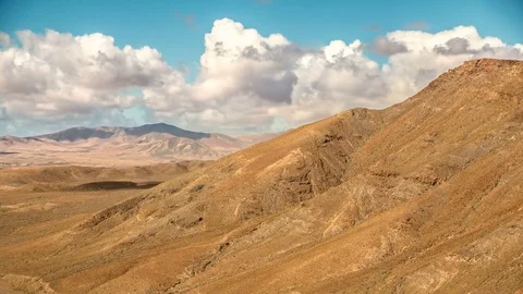 Timelapse clouds and shadows fly over a dry landscape in Fuerteventura, Spain Video stock 72358697