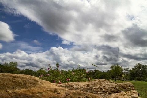 Timelapse of clouds and sky with large rock in the foreground Stock Footage 96593545