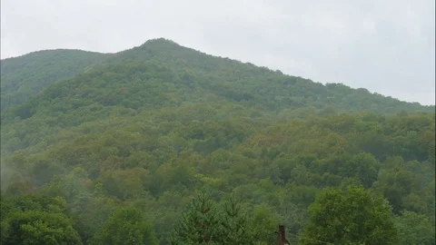 Timelapse of clouds appearing in mountains before rain. Video stock 83056963