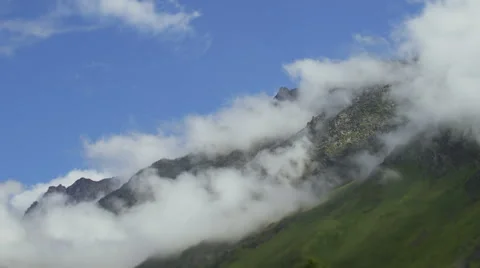 Timelapse. Clouds are running through the mountains. Stock Footage 66063077