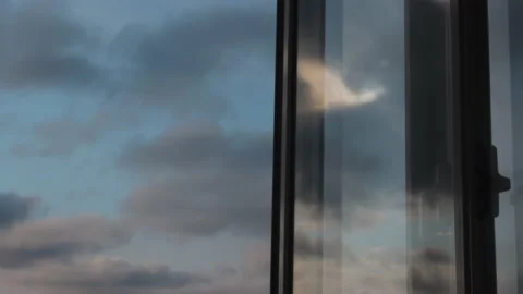 Timelapse of clouds on blue sky and as reflection on glass Stock Footage 130865065