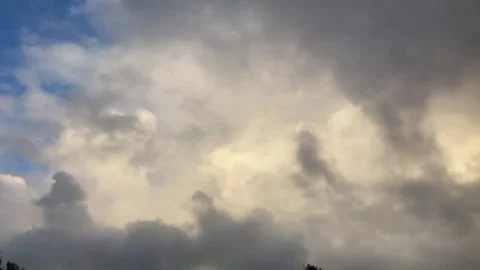 Timelapse clouds bright and dark, rainbow forms, then dark rain clouds move in Stock Footage 286167349